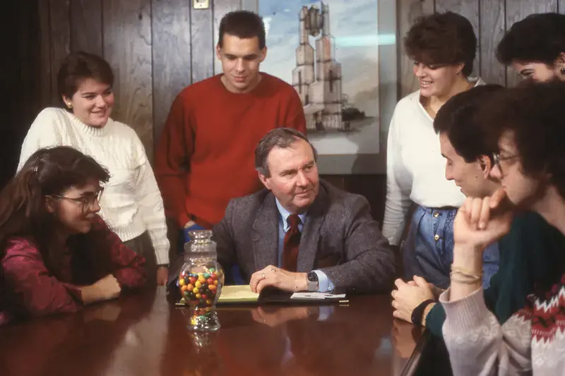 A group of students meeting with Jay Kesler in the 1980s