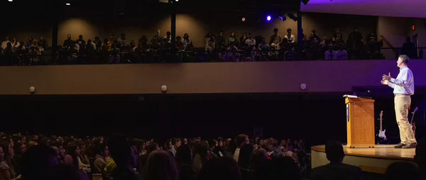 Side view of speaker at podium in a full chapel