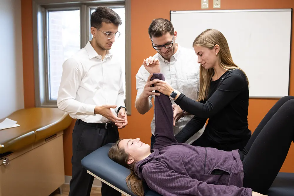 professor demonstrating physical therapy