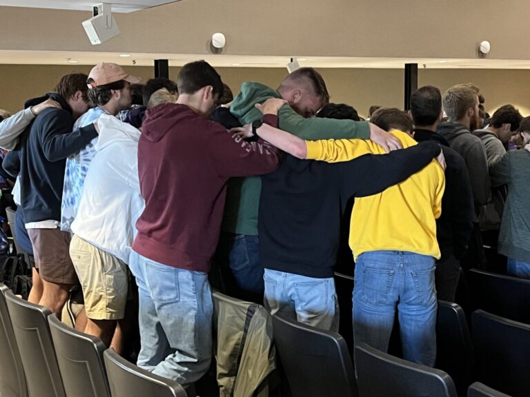students praying together