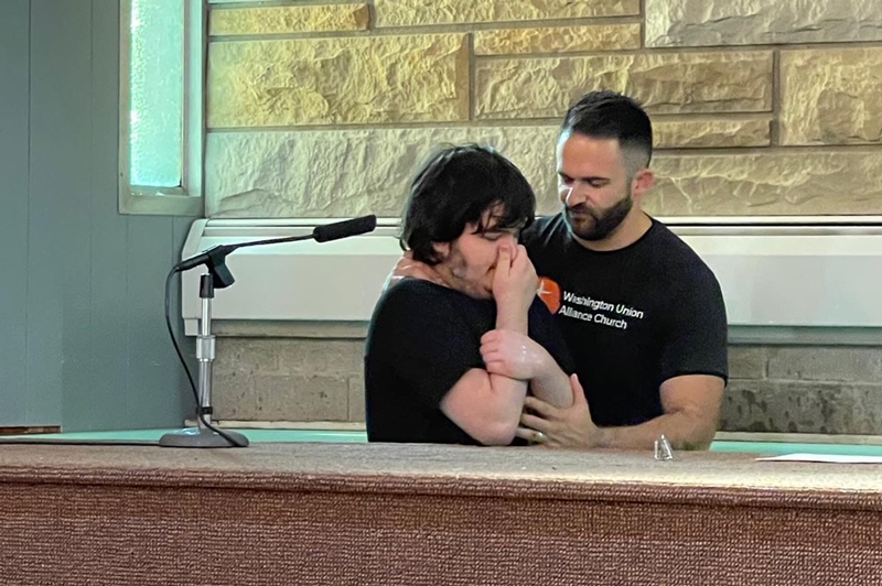 Pastor about to baptize teenager