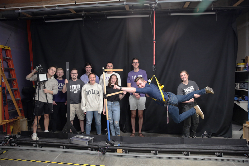 Engineering students pose with Virtual Reality system