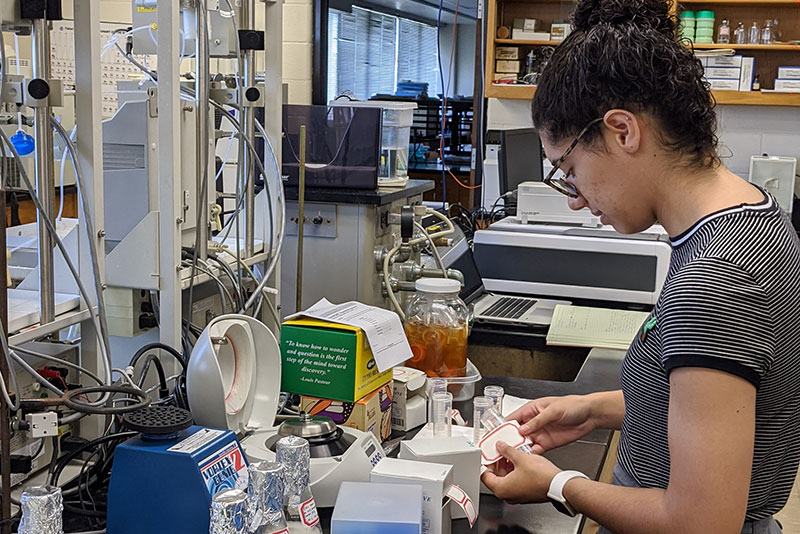 Taylor student performs research in lab.