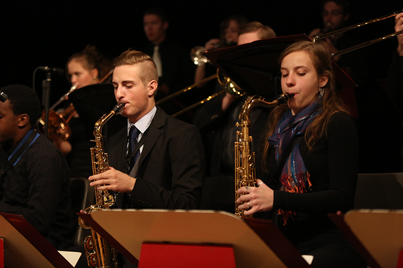 two saxophone players in orchestra