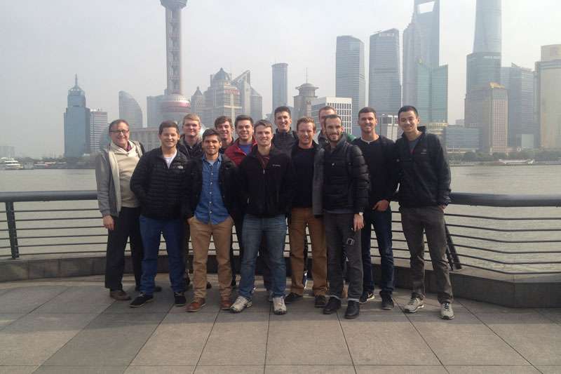 A group of Taylor Business students standing in front of misty skyline