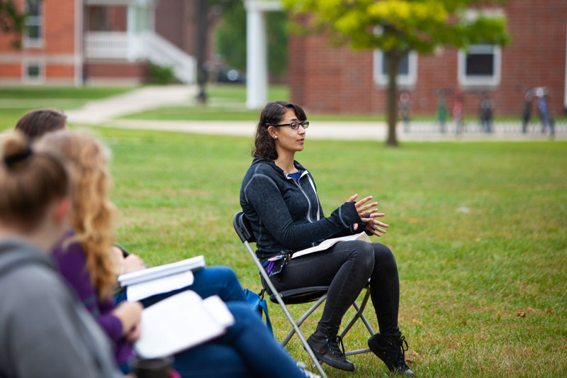 Student speaking while having class outside