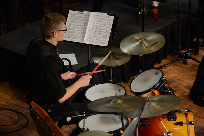 Student playing the drum set in the Jazz Band