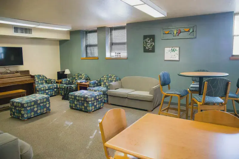 The lower level offers common spaces, a kitchen, and laundry