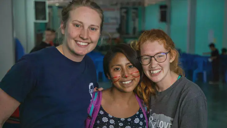Three female students smiling together