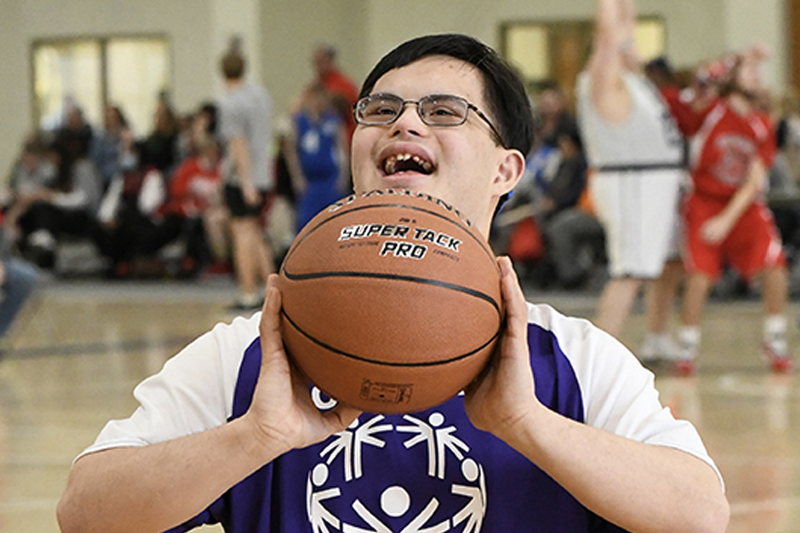 Special Olympics athlete holding basketball