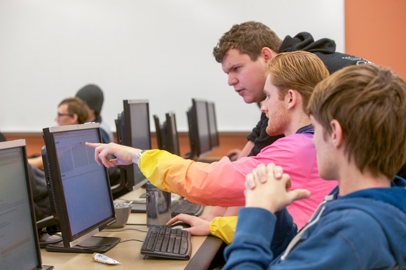 students collaborating at a computer