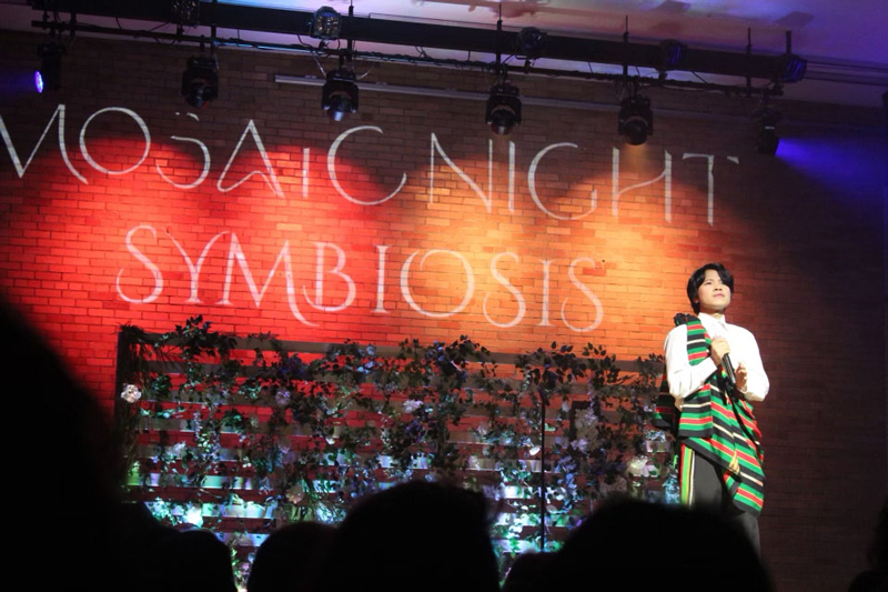 Student singing in Burmese at Mosaic Night