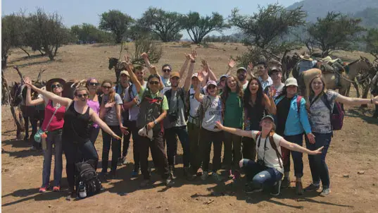 Taylor students celebrating in a desert in Chile.