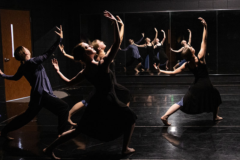 Four students perform modern dance