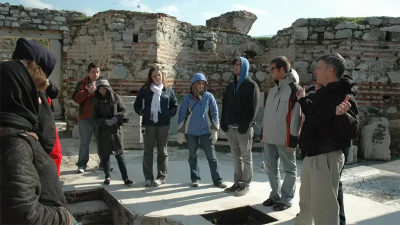 Taylor Bible students standing in a circle in some stone ruins