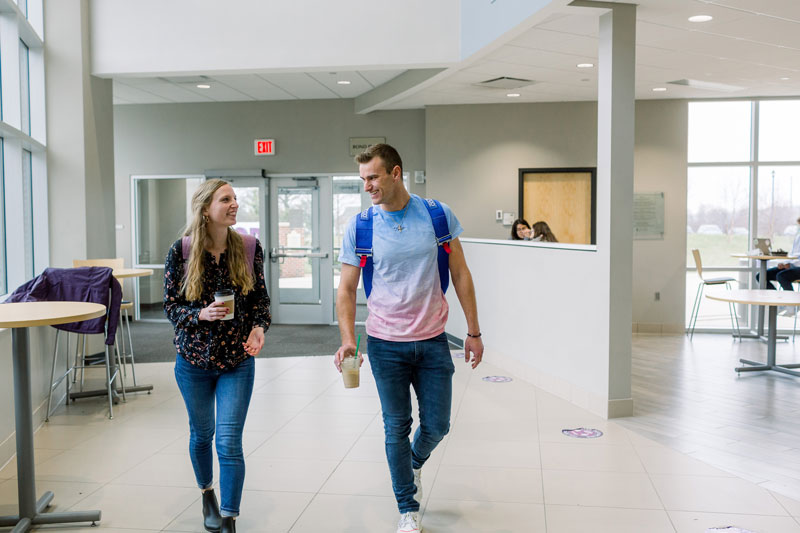 two students walk together in the student center
