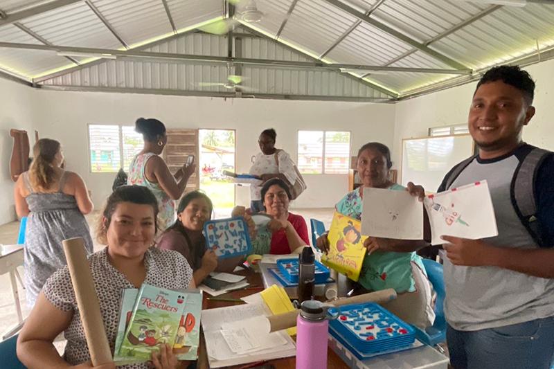 schoolteachers in Belize holding supplies