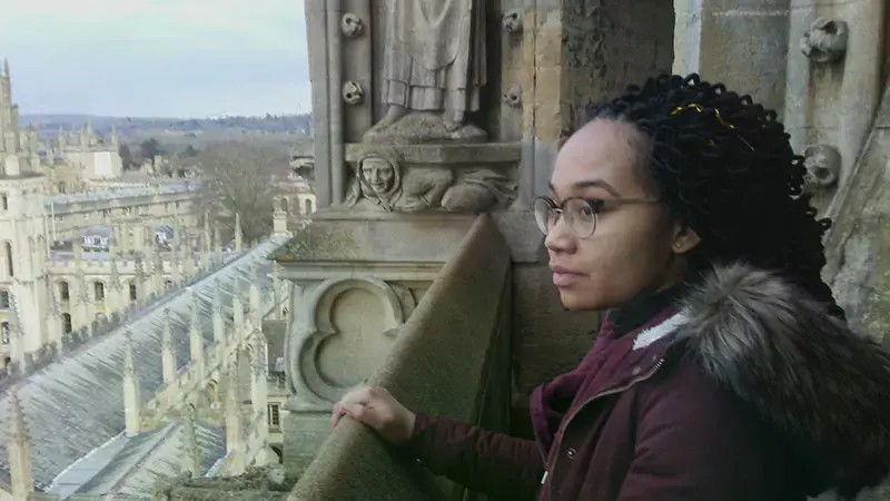 Female student overlooking Oxford University Campus from a tower