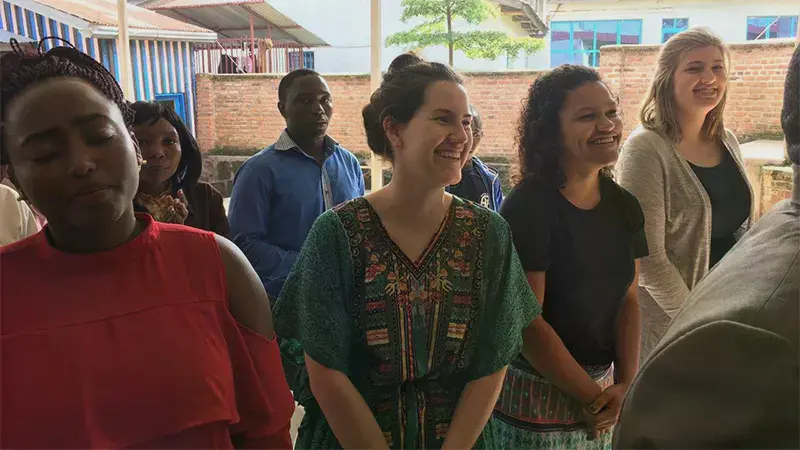 Students smiling in a worship service on a trip