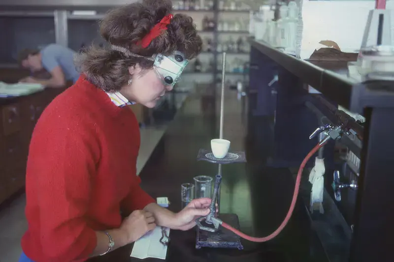 A student using science equipment in the 1980s