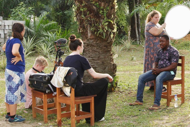 A film crew setting up an interview for a documentary