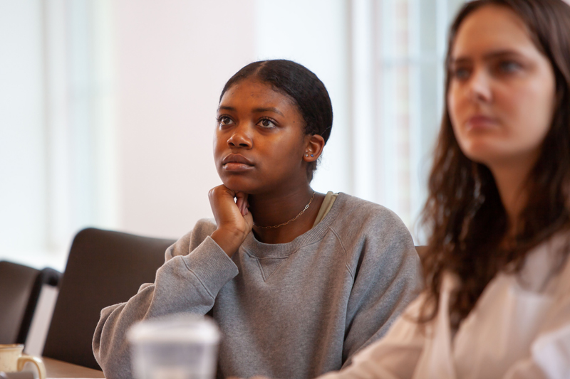 two female students listening in class