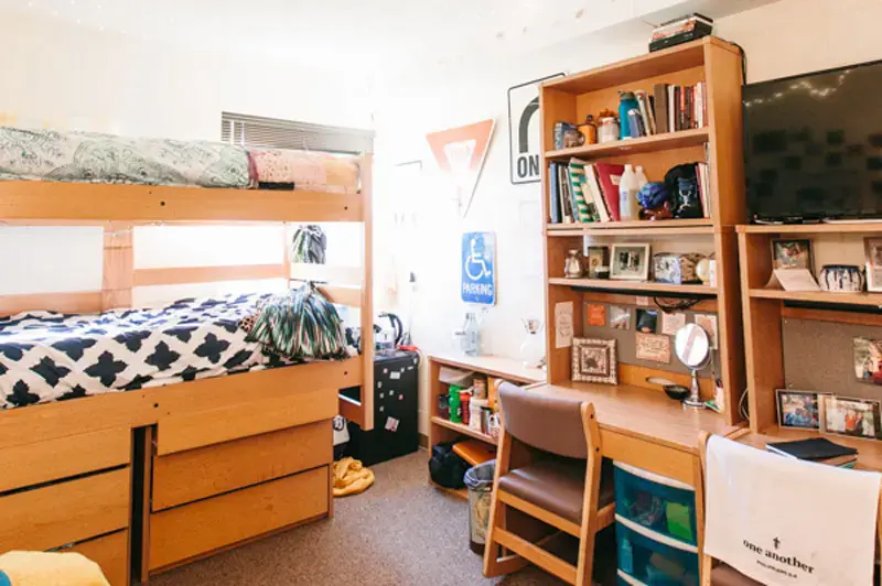 An Olson dorm room with street signs decorating the wall