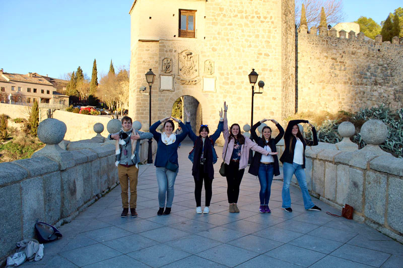 Students on a study abroad trip to Spain on a bridge