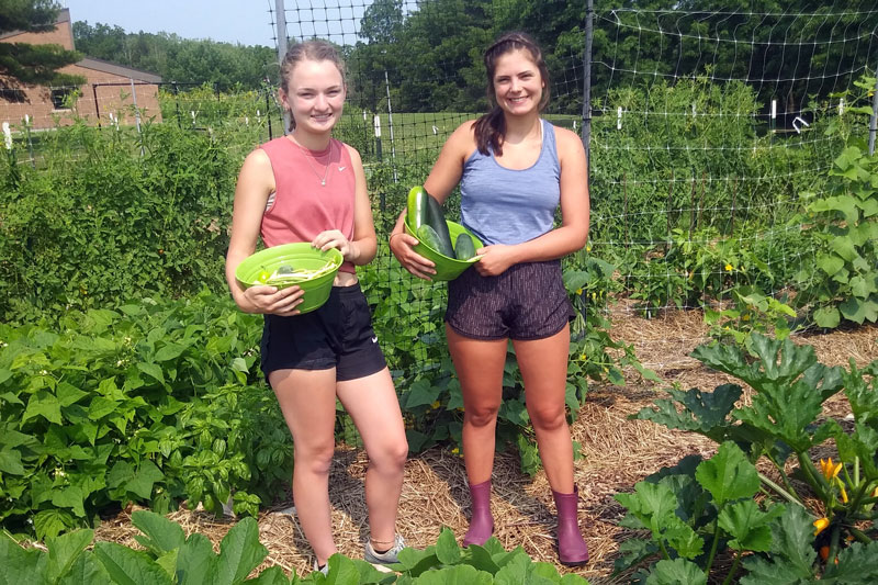 Students with bowls of produce outside Randall Environmental Center