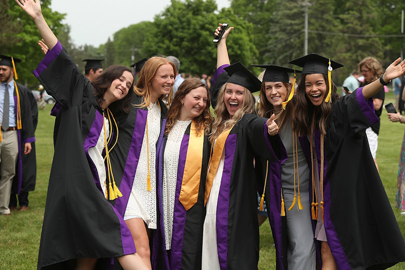 group of female students celebrating after commencement