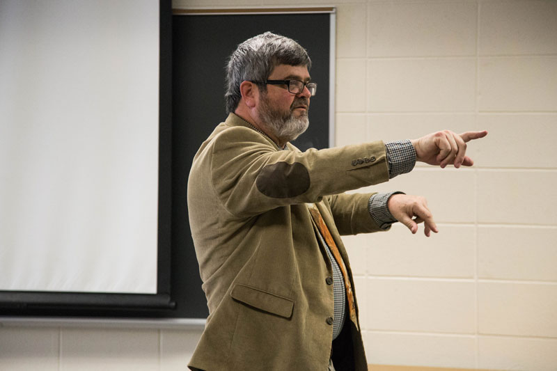 Professor pointing while speaking to a class