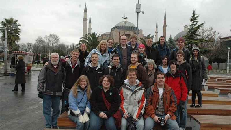 Taylor Bible students taking a group photo in front of a large place of worship