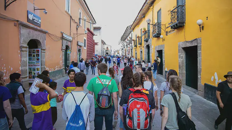 Taylor students exploring a broad street of colorful buildings