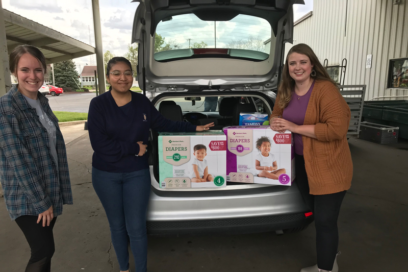 three social wor k majors with a donation of diapers