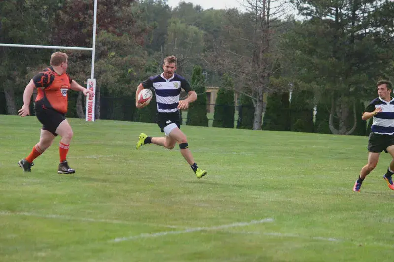 Taylor rugby players advancing the ball