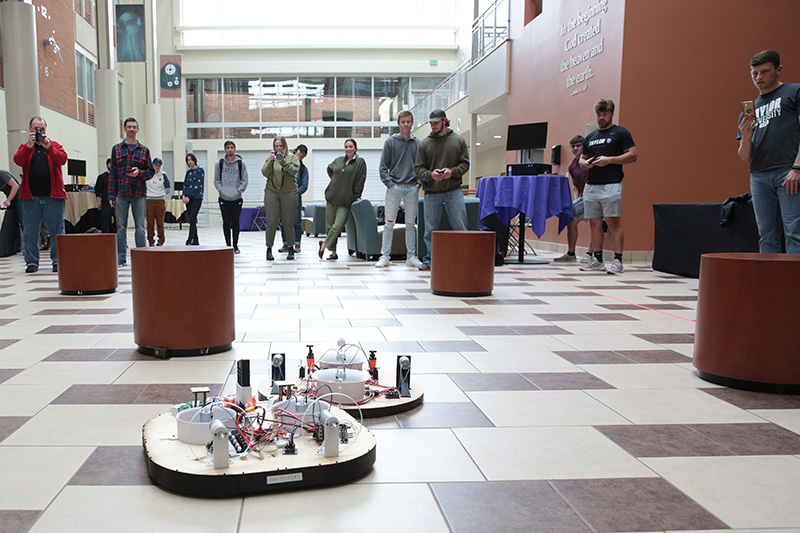 Students observe their battle bots fighting