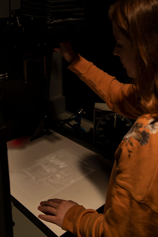 student working in a darkroom