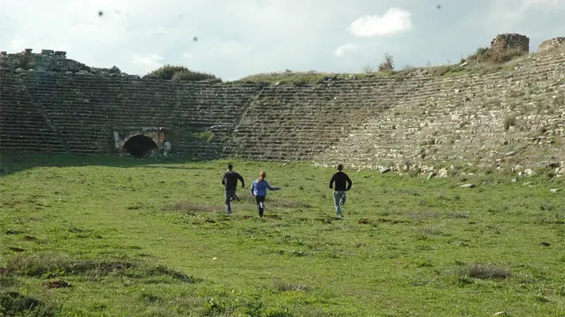 Taylor students running in an ancient stadium in Greece