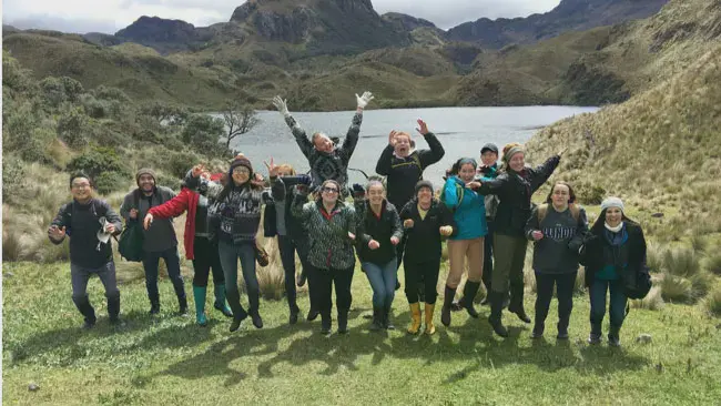 Taylor students celebrating in front of a lake in South America