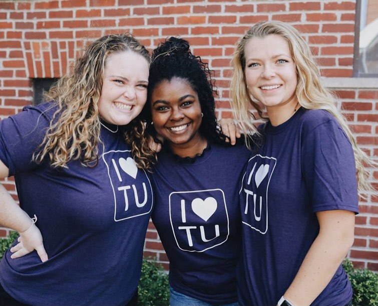 Three female students in I Love TU shirts