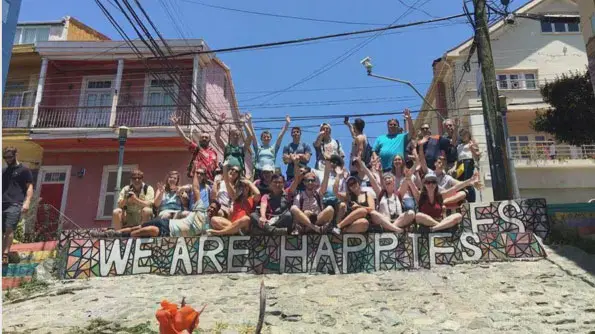 Large group of Taylor students celebrating on top of some street art steps in Valparaiso, Chile