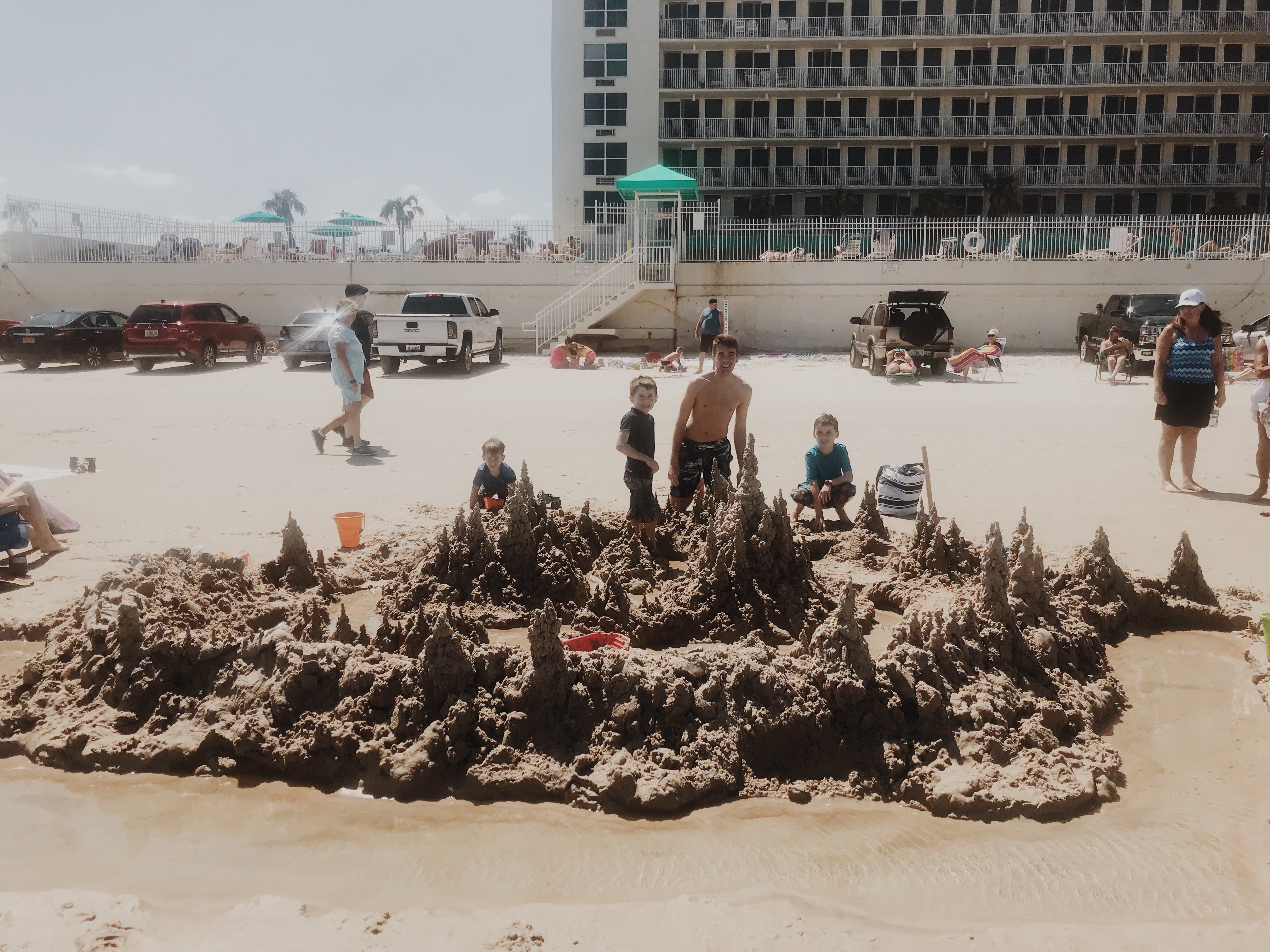 A group building an immense sand castle