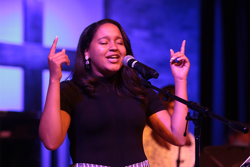 student leading worship in chapel