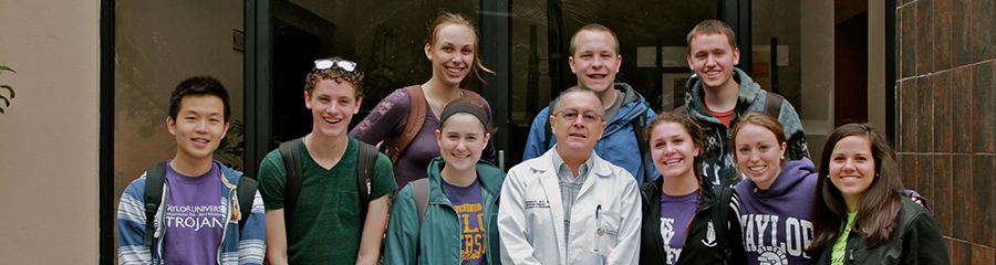 Group of Pre-Med Students in Front of Door with a Professor.