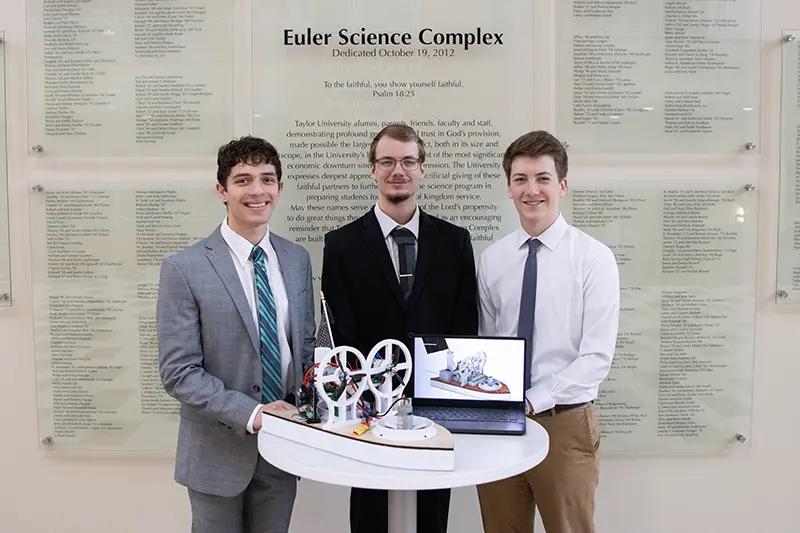 3 engineering male students with hovercraft