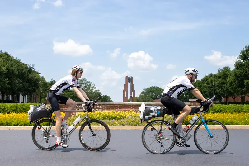 Jackson and Jeff biking past Taylor bell tower