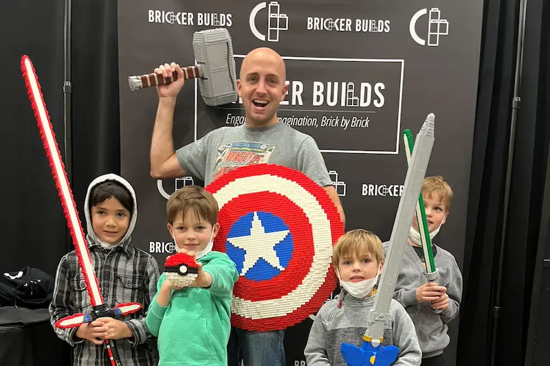 Children posing with LEGO creations
