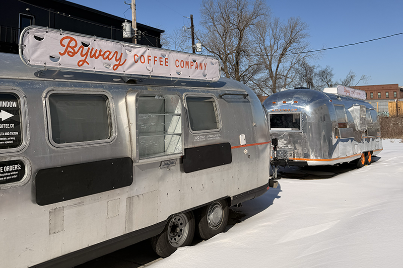Bryway Coffee Company trailer parked in the snow, with a second shiny silver trailer in the background.