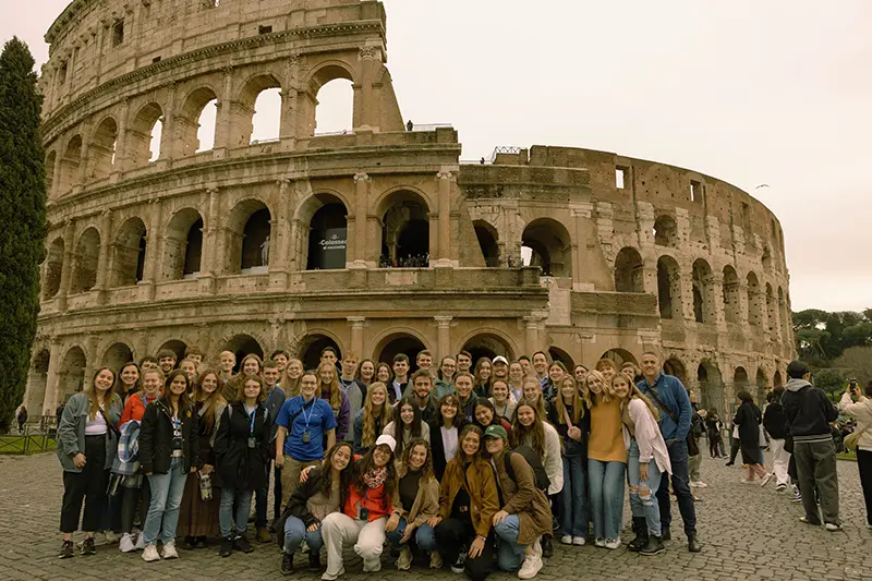 Honors guild students in front of the colosseum
