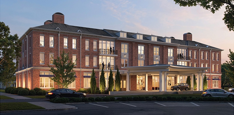 Exterior rendering of a three-story brick hotel with a covered entrance and parked cars at dusk.